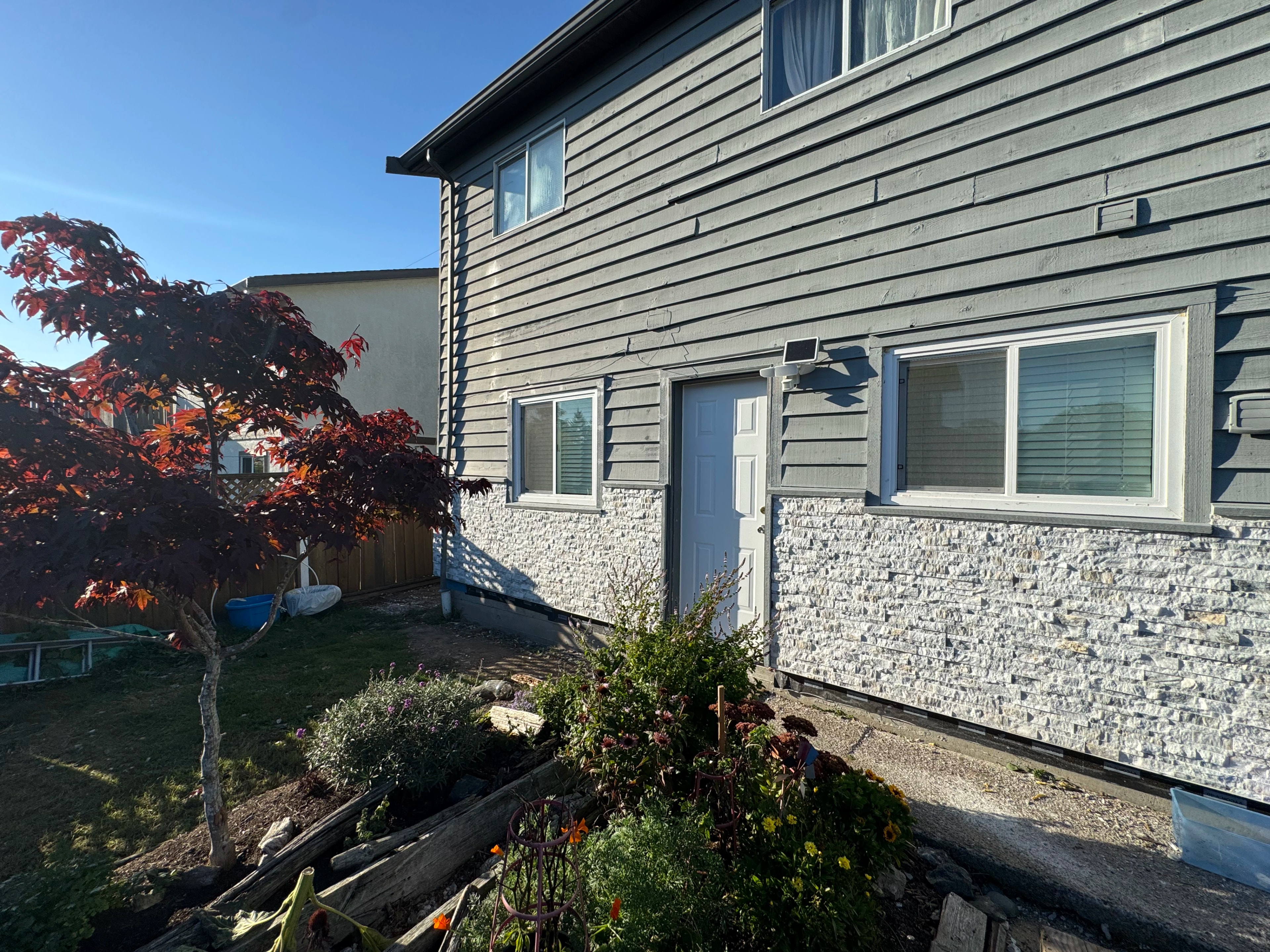 gray siding and forest shed by CVR Construction